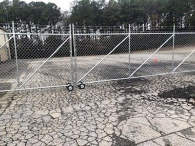 Chain Link Fence Top Of Cracked Ground — Covington, GA — Barbara's Fence Company, Inc.