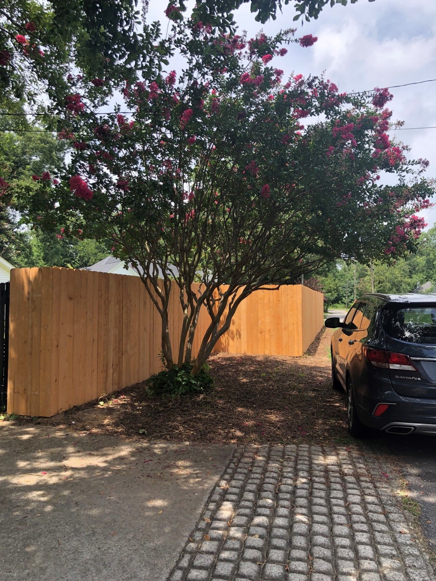 Car Parked In Front Of Wooden Fence — Covington, GA — Barbara's Fence Company, Inc.