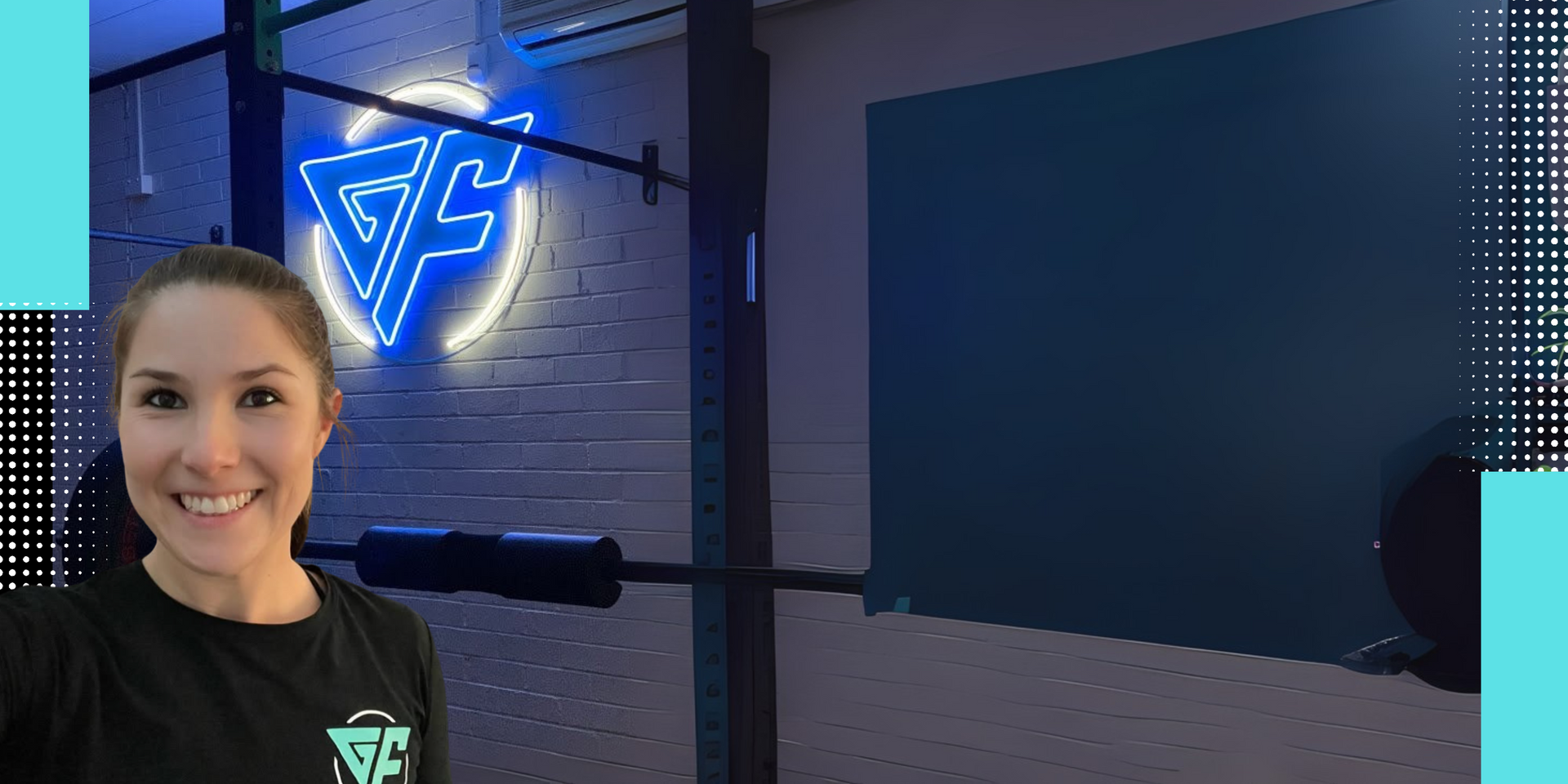 Woman smiling in a gym with a neon logo.