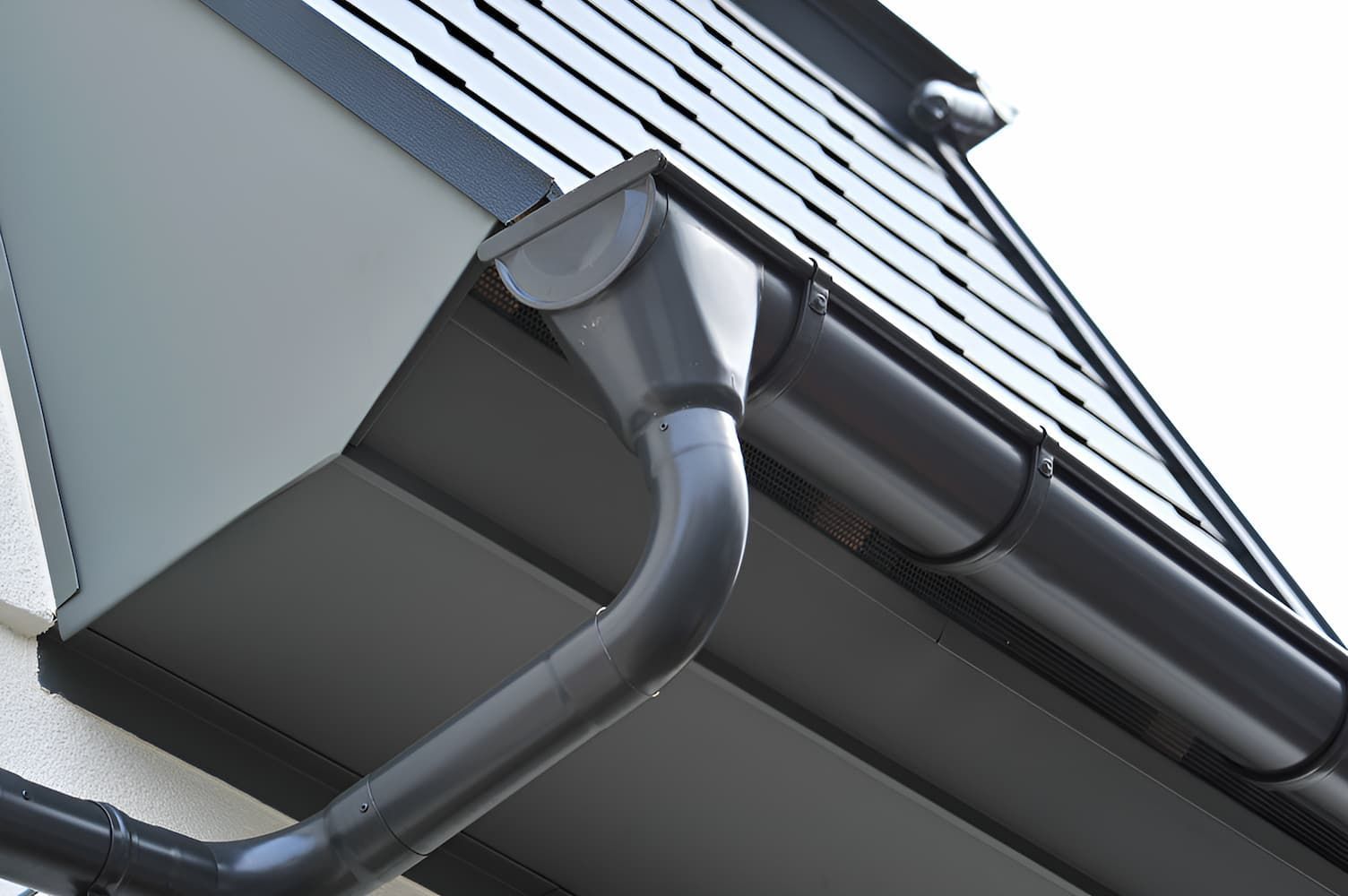A Close Up Of A Black Gutter On The Side Of A Building — GPS Plumbing, Drainage & Gasfitting In Dubbo, NSW