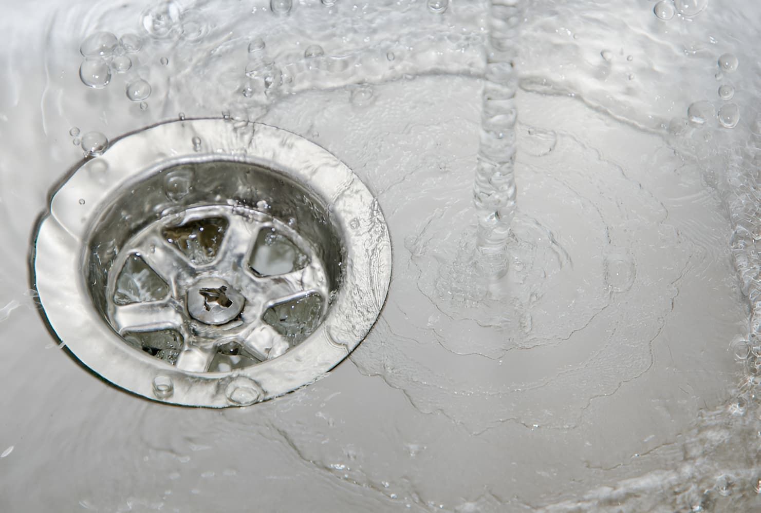 A Close Up Of A Sink Drain With Water Running Down It — GPS Plumbing, Drainage & Gasfitting In Narromine, NSW