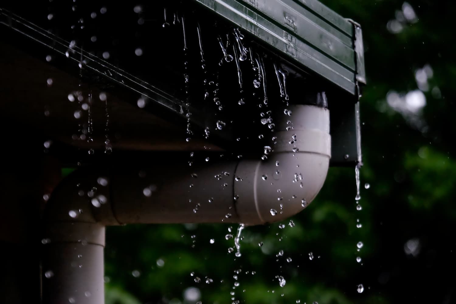 Rain Is Falling From The Gutter Of A House — GPS Plumbing, Drainage & Gasfitting In Dubbo, NSW