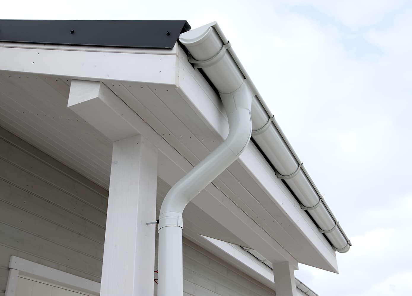A White Gutter On The Side Of A House — GPS Plumbing, Drainage & Gasfitting In Dubbo, NSW