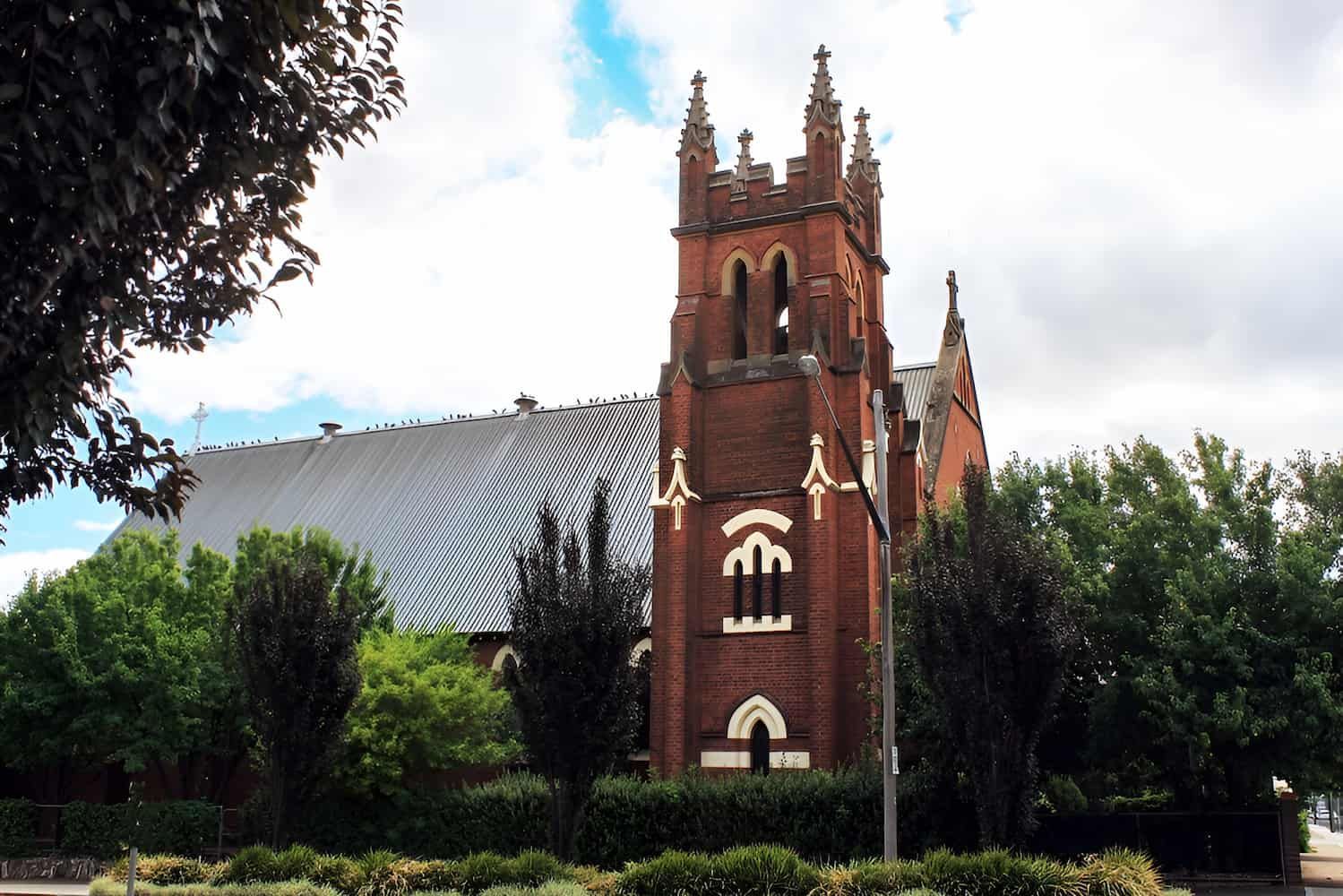 A Large Brick Building With The Word Faith On It — GPS Plumbing, Drainage & Gasfitting In Wellington, NSW