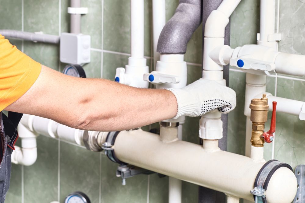 Plumber in White Gloves Replacing Pipes