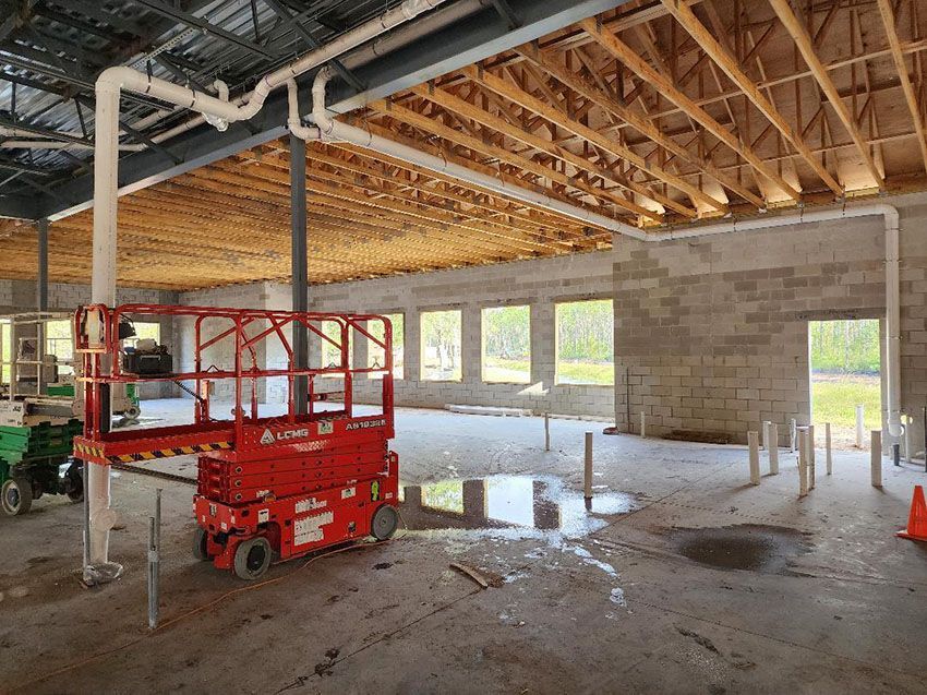A Red Scissor Lift Parked - Clay County, FL - Clay County Master Plumbing, LLC