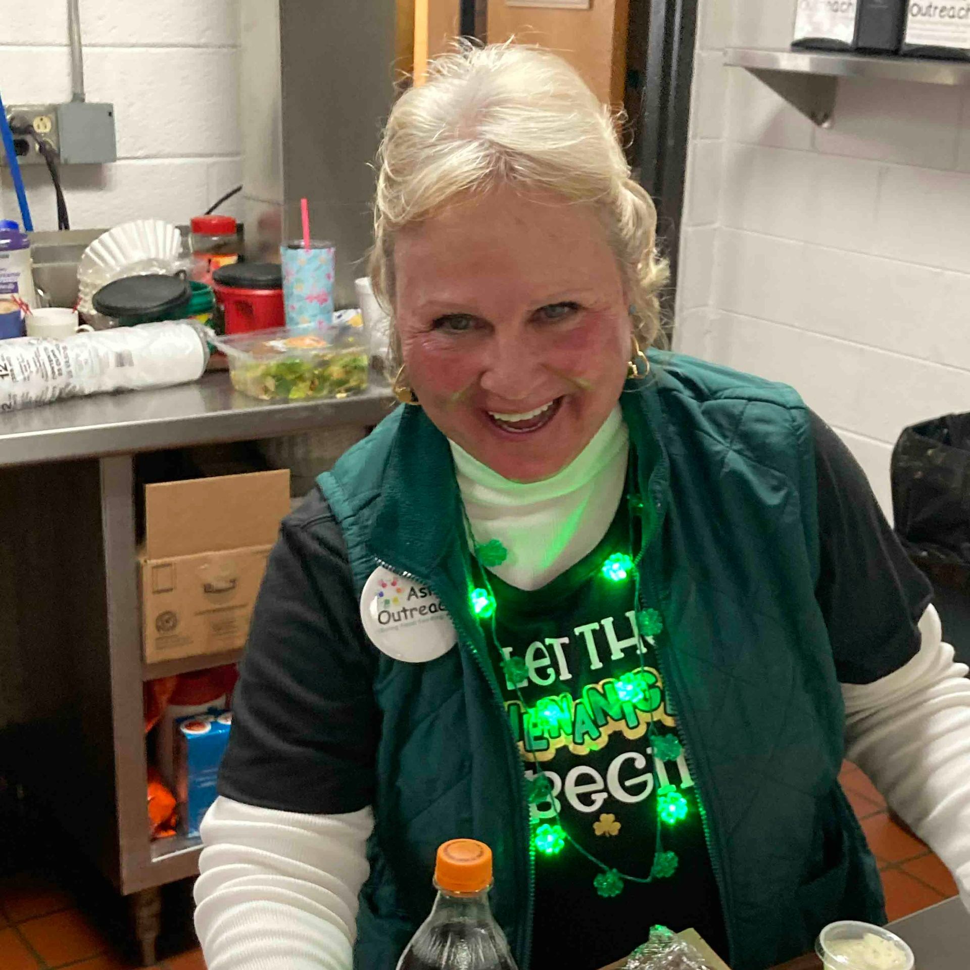 A woman wearing a shirt that says let the party begin