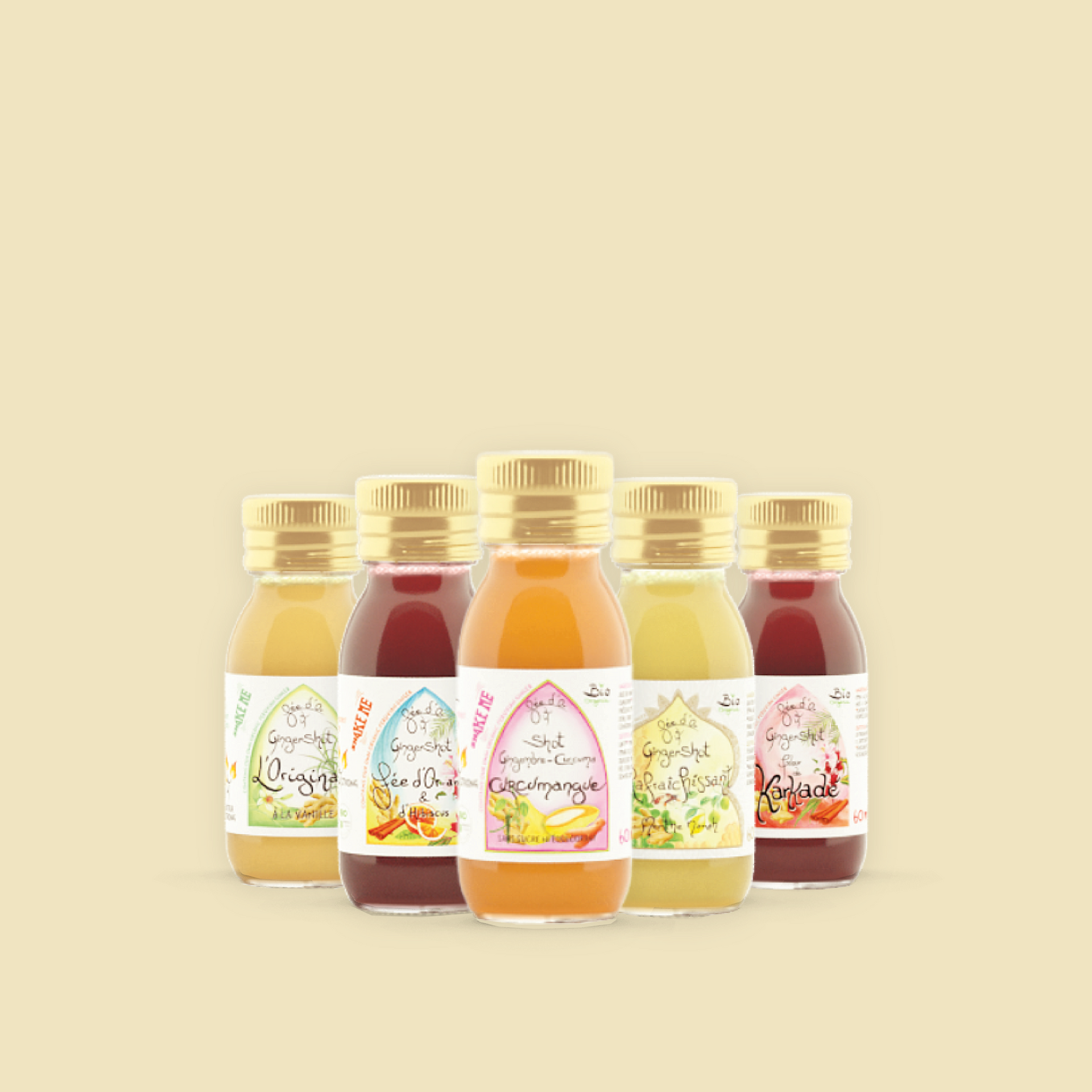 Cinq petites bouteilles aux bouchons dorés, remplies de jus colorés, se détachent sur un fond jaune pâle.
