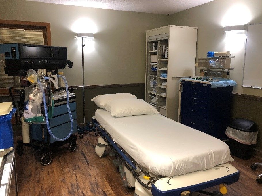 an empty medical room with a bed and a monitor at the albany clinic in carbondale Illinois