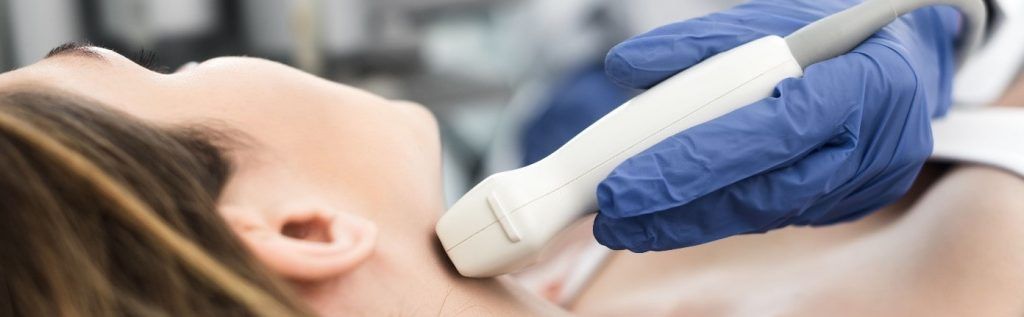 a woman is getting an ultrasound of her neck .