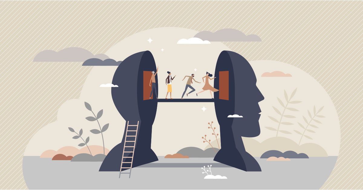 Two people building a bridge between giant dark head silhouettes, with a ladder and soft clouds in the background