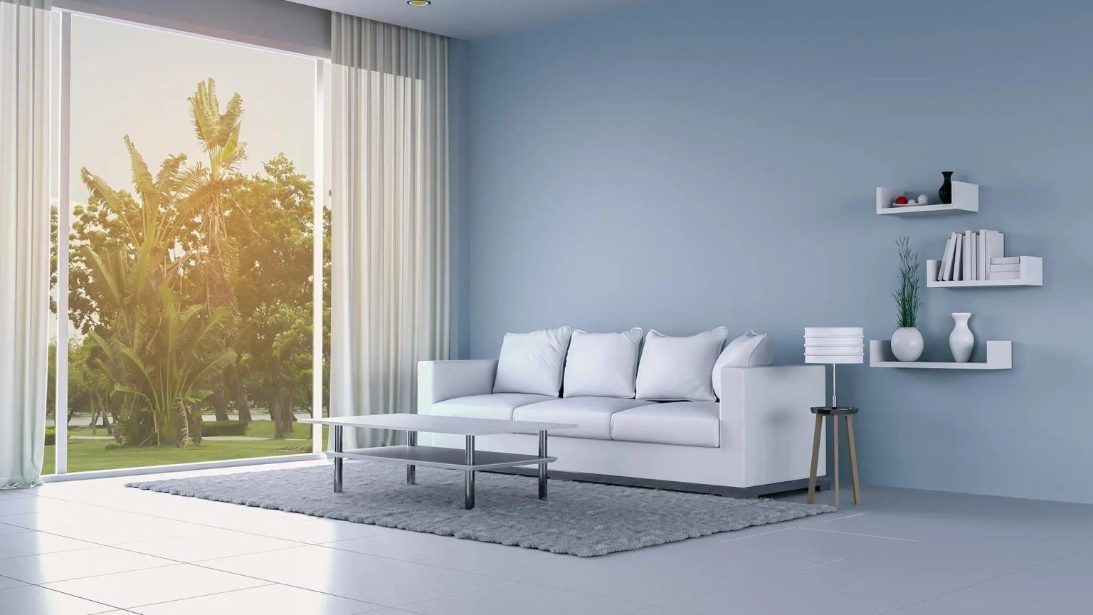 Minimal living room with white sofa, gray rug, wall shelves, and sunlight from a large window.