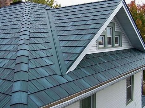Blue-gray metal roof with dormer windows on a house