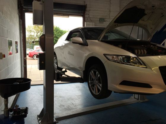 Two cars in the garage for repairs and servicing in Edinburg