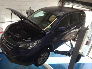 Two cars undergoing repairs