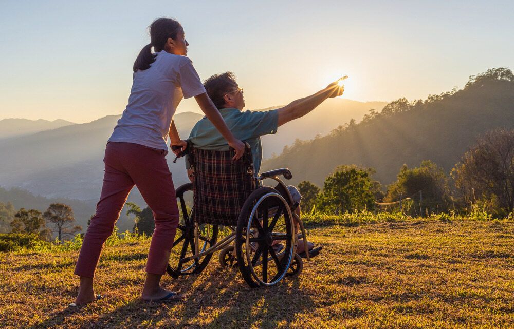 A Women Hold Women on the Wheel Chair — Active Lifestyle Supports In Tullimbar, NSW