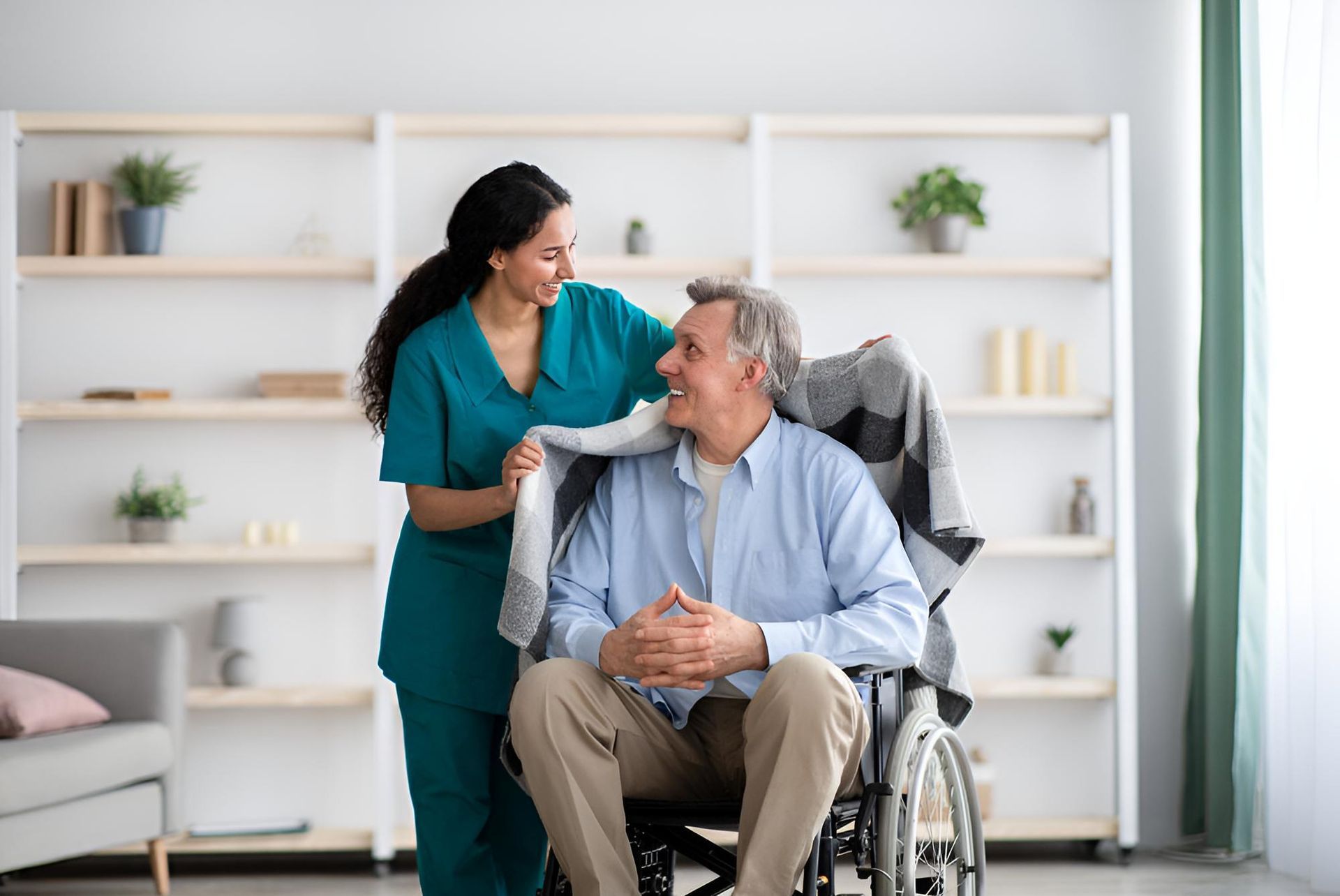 A Nurse is Helping an Elderly Man in a Wheelchair — Active Lifestyle Supports In Tullimbar, NSW