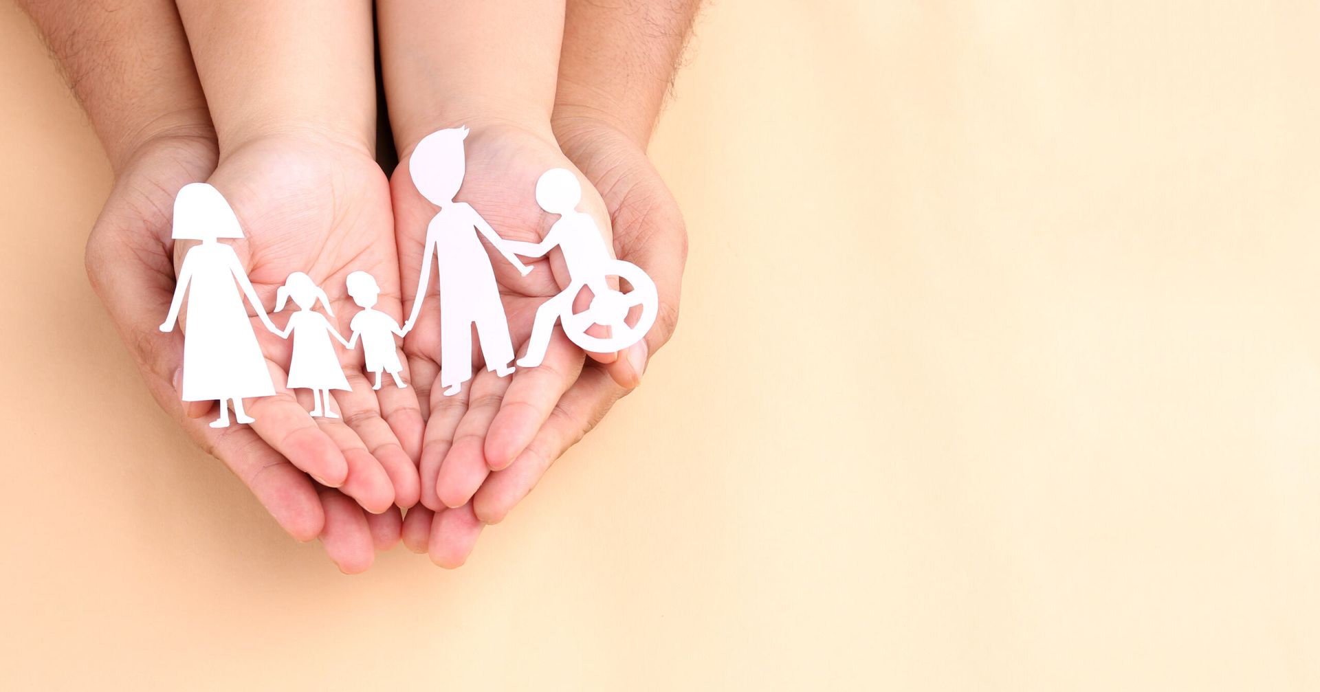 A Man and a Child Are Holding a Paper Cut Out of a Family — Active Lifestyle Supports In Wollongong, NSW
