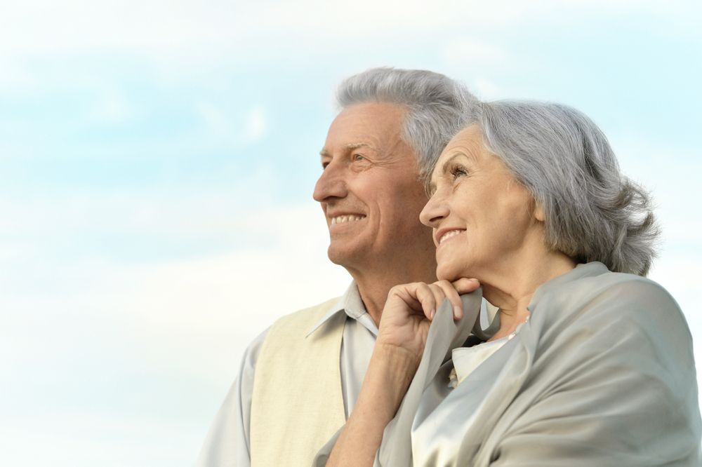 A Man and a Woman Are Standing Next to Each Other and Smiling — Active Lifestyle Supports In Tullimbar, NSW