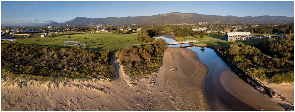 An Aerial View of a River Surrounded by Trees and Mountains — Active Lifestyle Supports In Wollongong, NSW