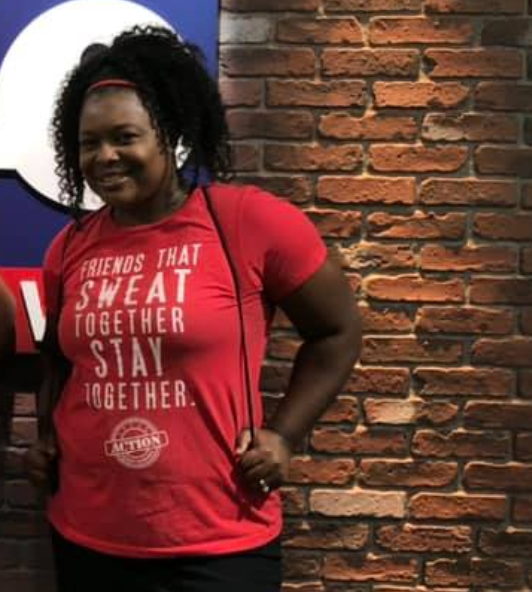 A woman wearing a red shirt that says friends that sweat together stay together