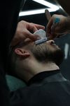 man recieving straight razor beard trim