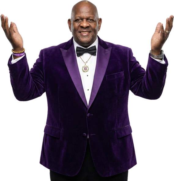 Smiling man in a purple velvet blazer, white shirt, black bow tie, and raised hands on a white background
