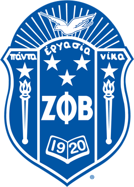 Blue and white Zeta Phi Beta Sorority shield logo with torches, stars, Greek letters, and 1920