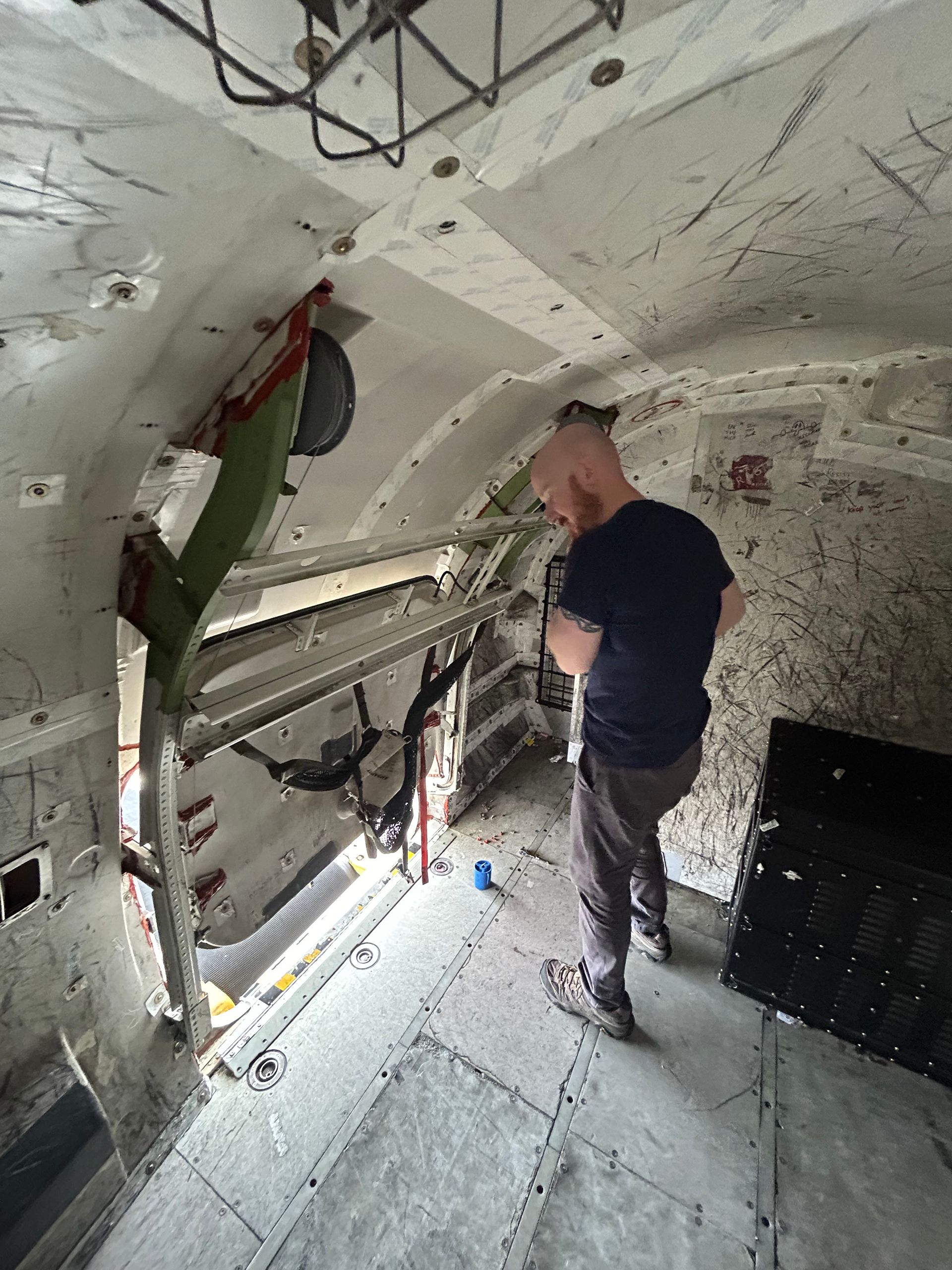 A man is standing in a room with a ladder.