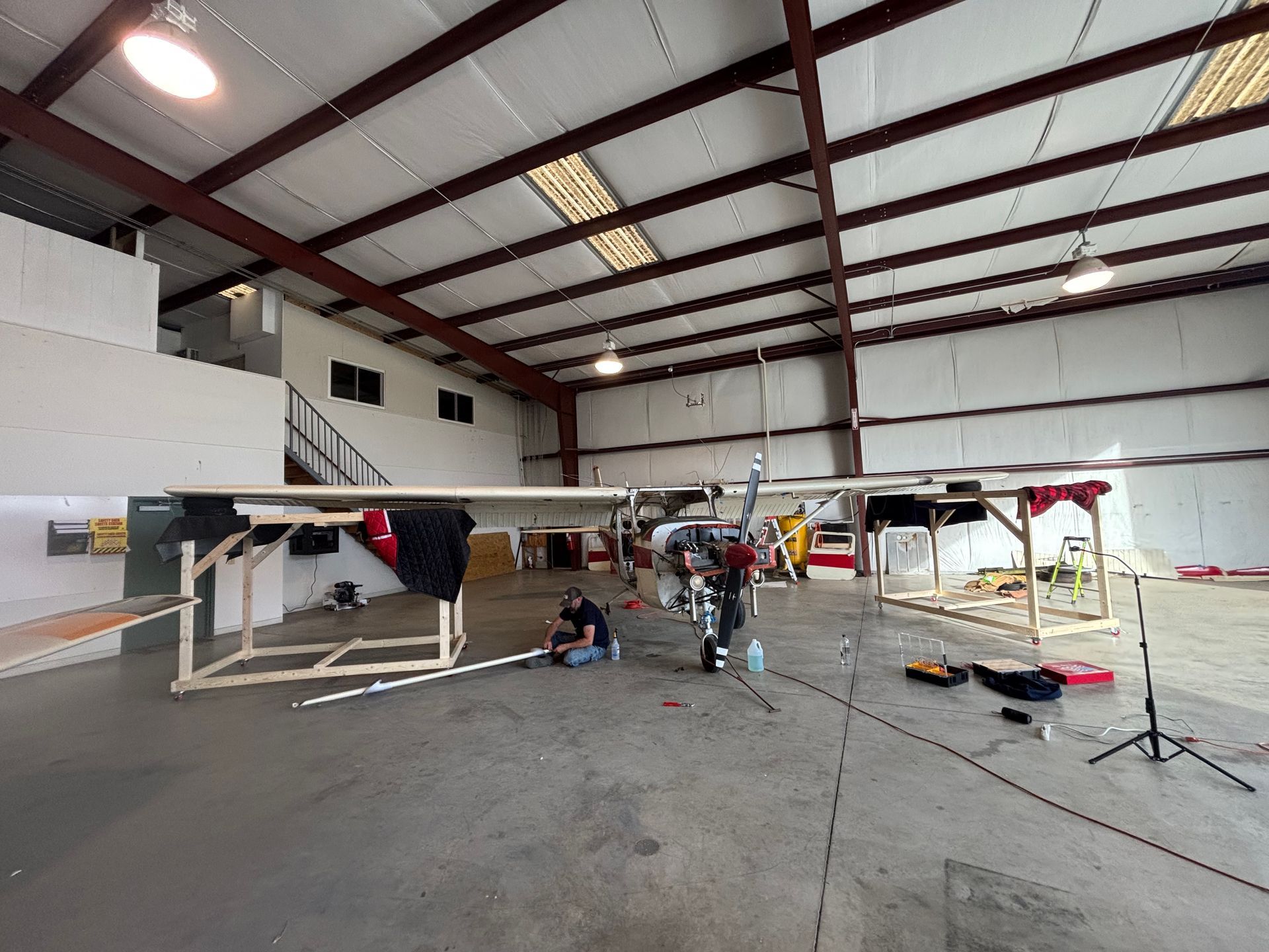 A plane is being built in a large hangar