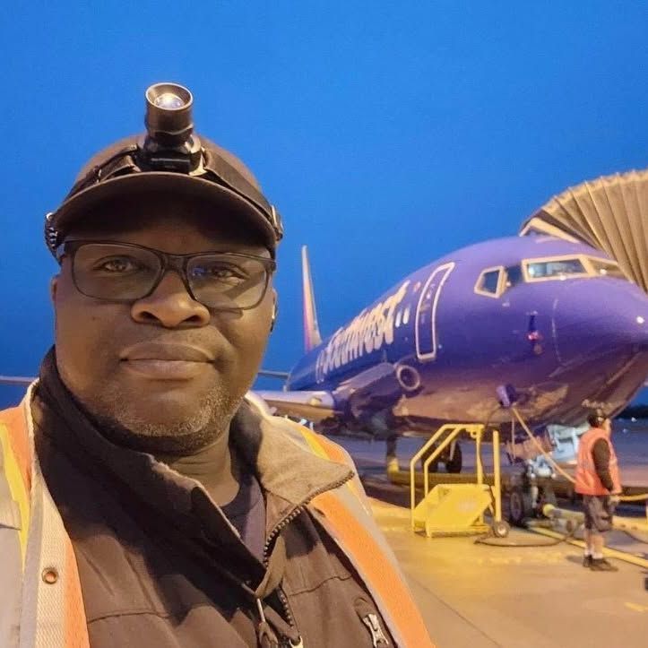 A man standing in front of a purple southwest airplane