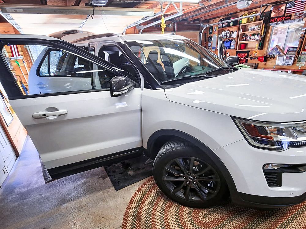 A white 2018 Ford Explorer XLT getting detailed by R&T Auto.