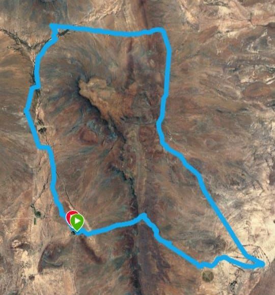 An aerial view of a mountain with a blue line around it