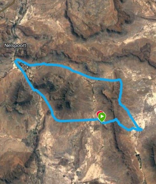 An aerial view of a mountain range with a blue line going through it