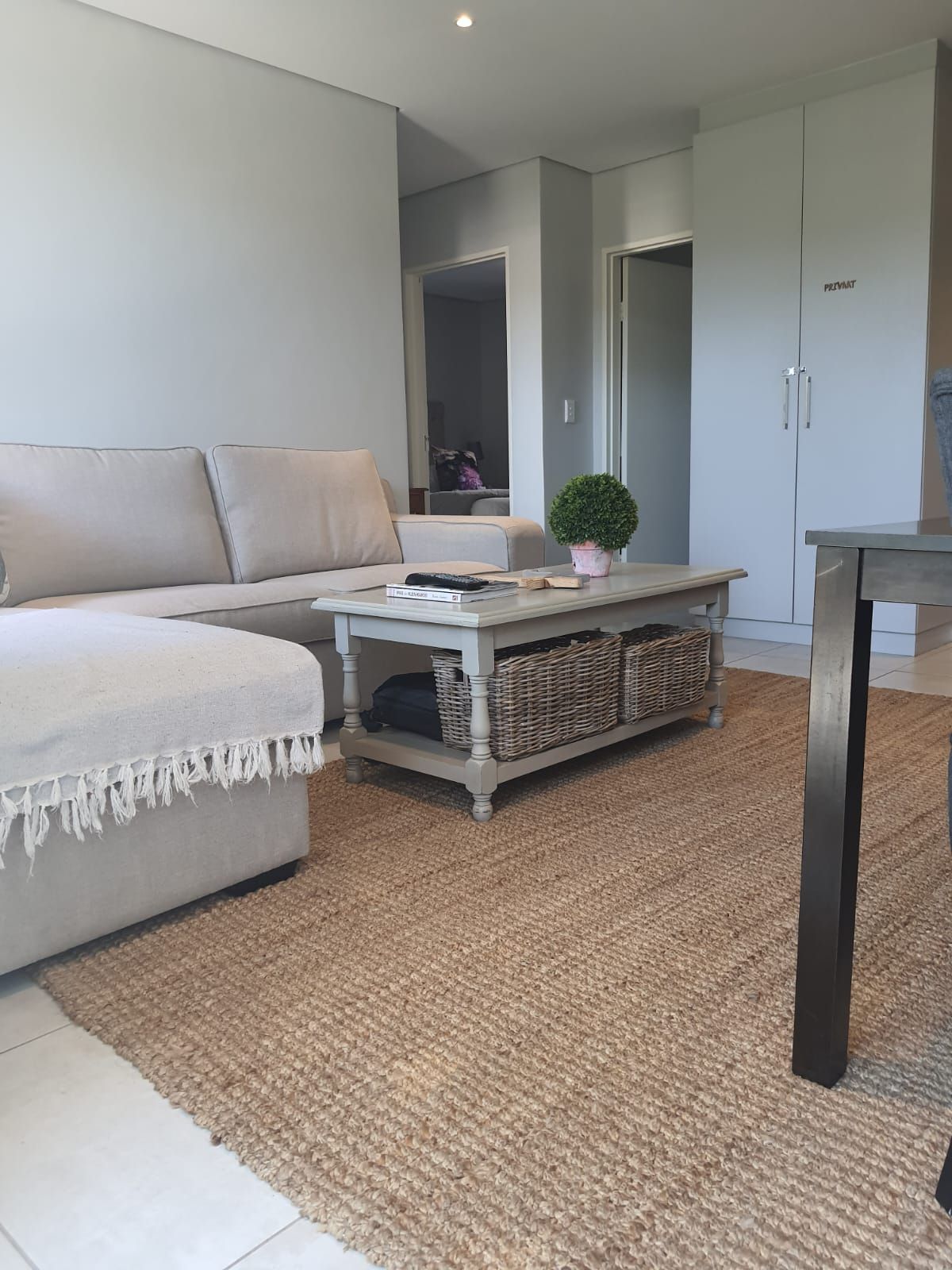 A living room with a couch , coffee table , and chairs.