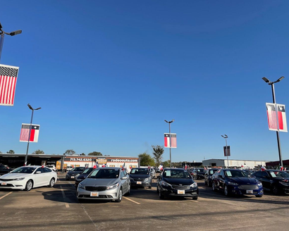 a car dealership with a sign that says welcome