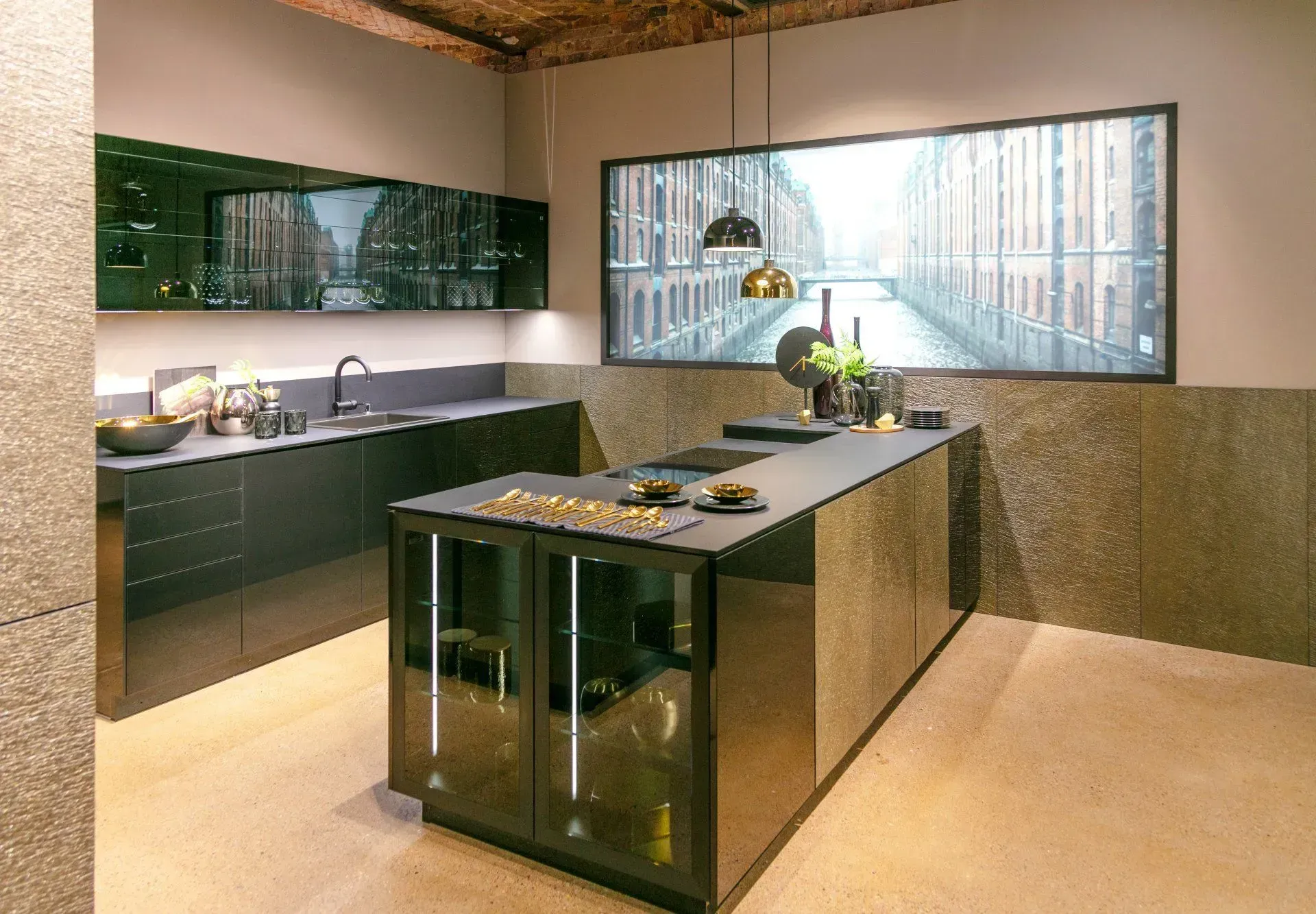 Modern dark green kitchen with island, overhead cabinets, and a large window featuring a city view.