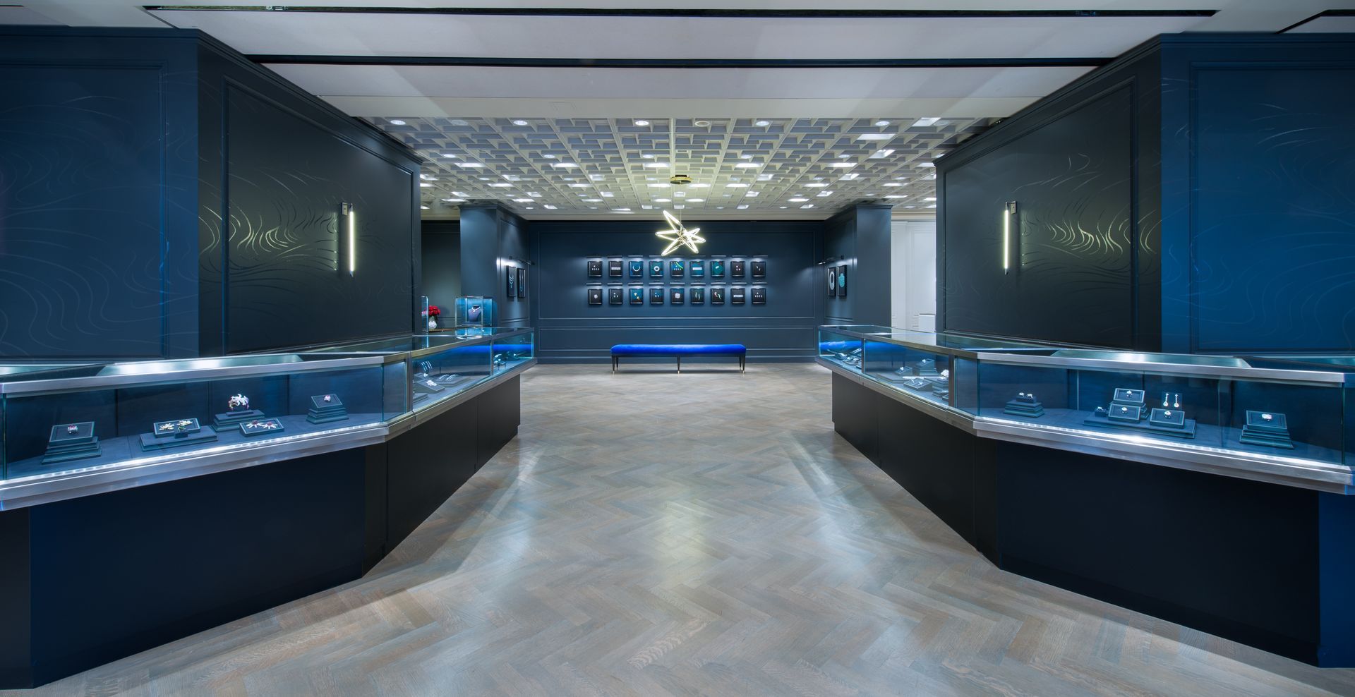 Modern jewelry store interior with glass display cases and a polished gray floor