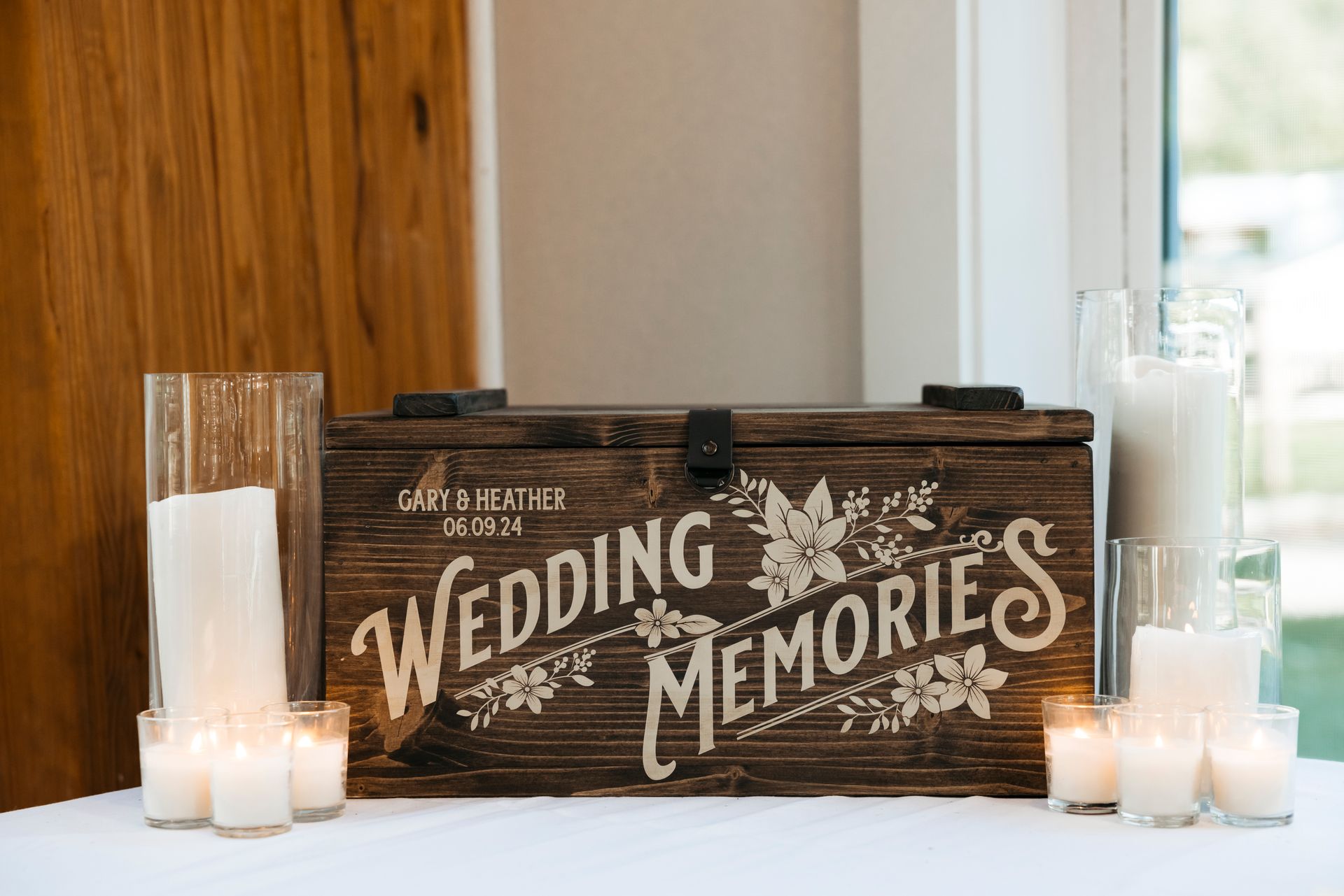 Rustic wooden wedding memories sign with candles on a white table
