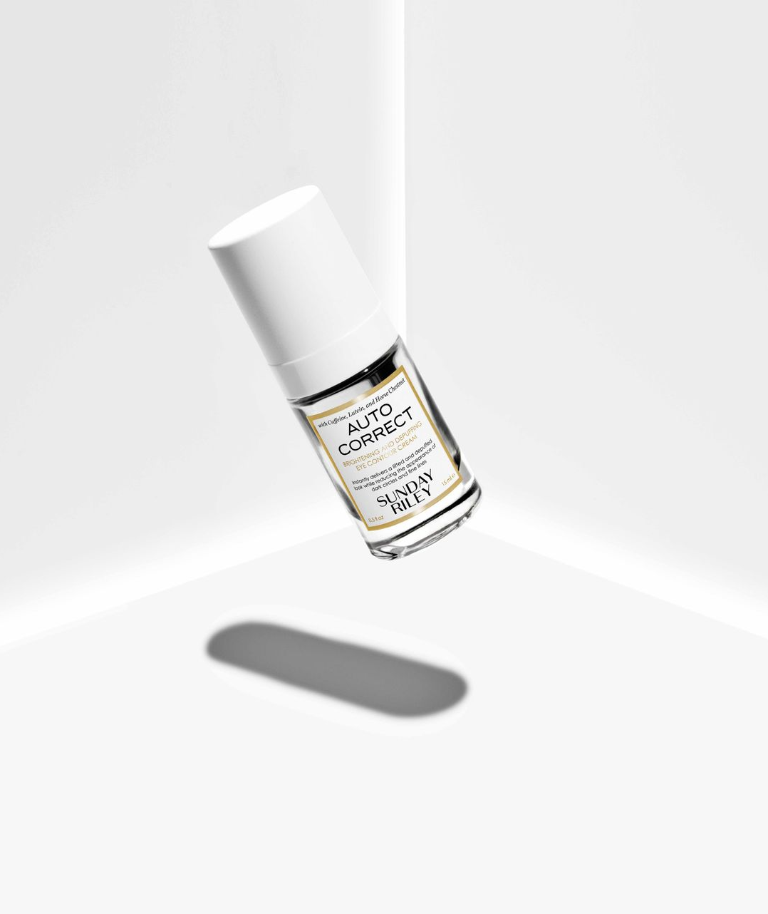 White cosmetic bottle floating on a white background with a soft shadow beneath