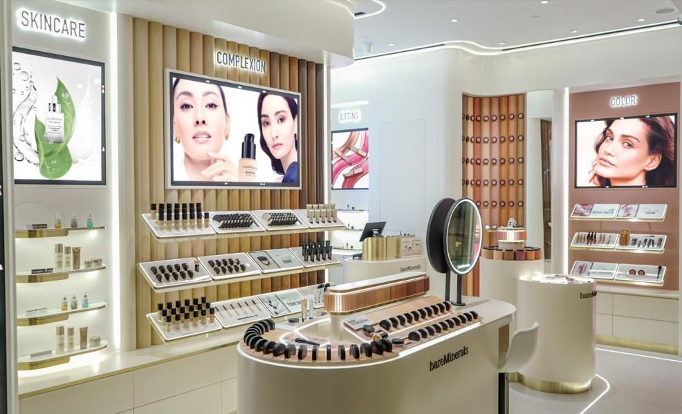 Bright cosmetics store interior with skincare displays, mirrored counters, and product shelves under soft lighting