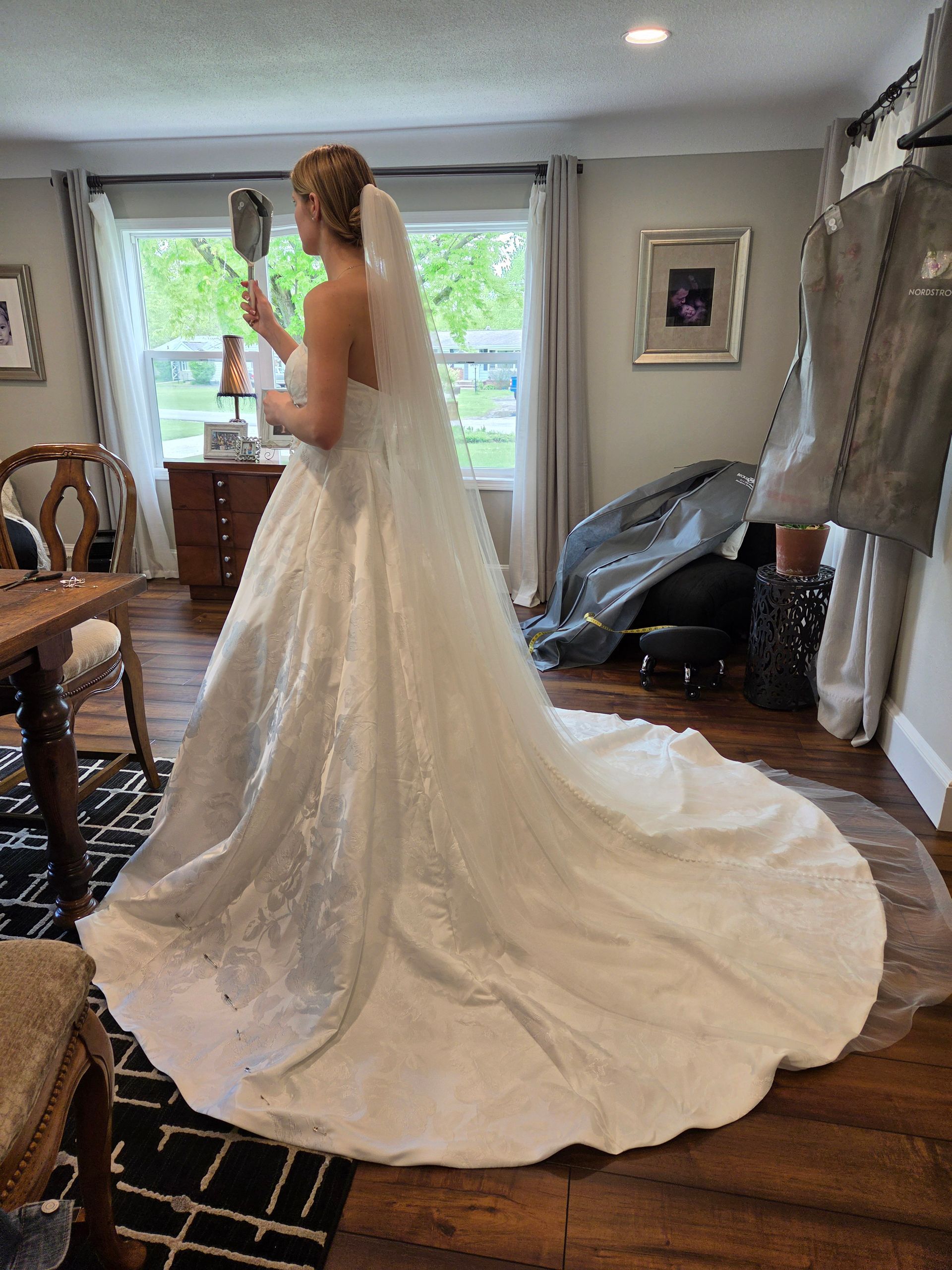 Woman in wedding gown at bridal fitting appointment with Sonya Garcia