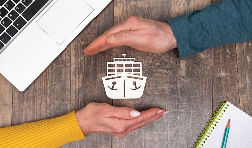 Marine insurance with hands in a protective gesture