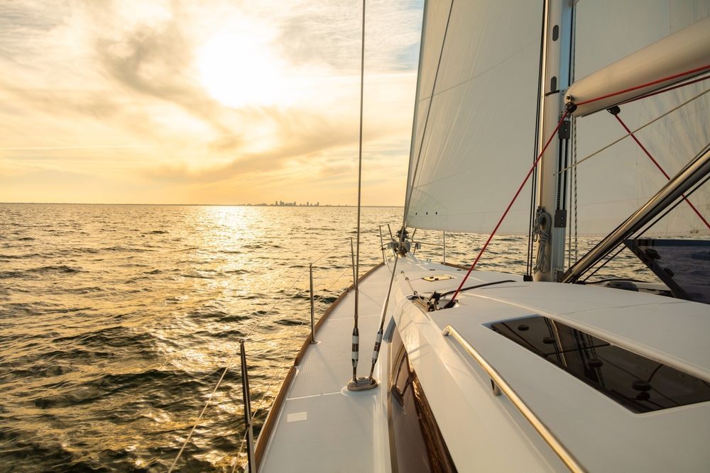 A sailboat is floating on top of a large body of water.