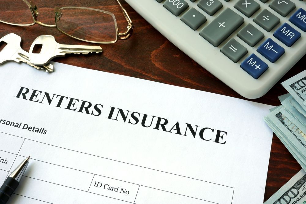A calculator is sitting on top of a rental insurance form