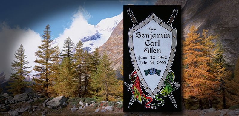 A memorial plaque featuring a shield with a name, flanked by swords, set in a mountain scene.