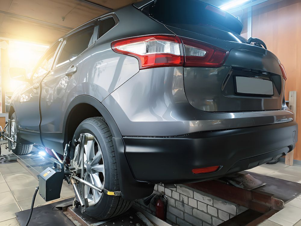 A Car Wheel Is Being Aligned In A Garage With A Machine — Border Bandag Tyre Service In South Albury, NSW