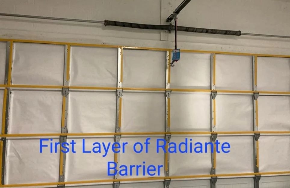 A picture of a garage door with the words first layer of radiante barrier