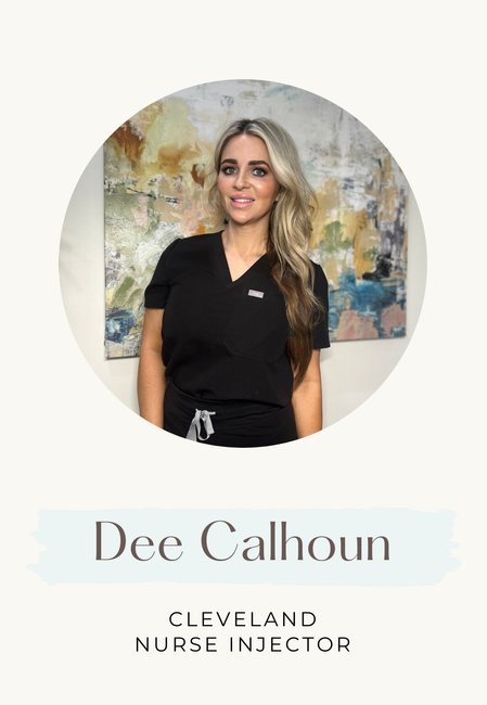 Dee Calhoun, Cleveland Nurse Injector, wearing black scrubs, smiling, with a painting in the background.