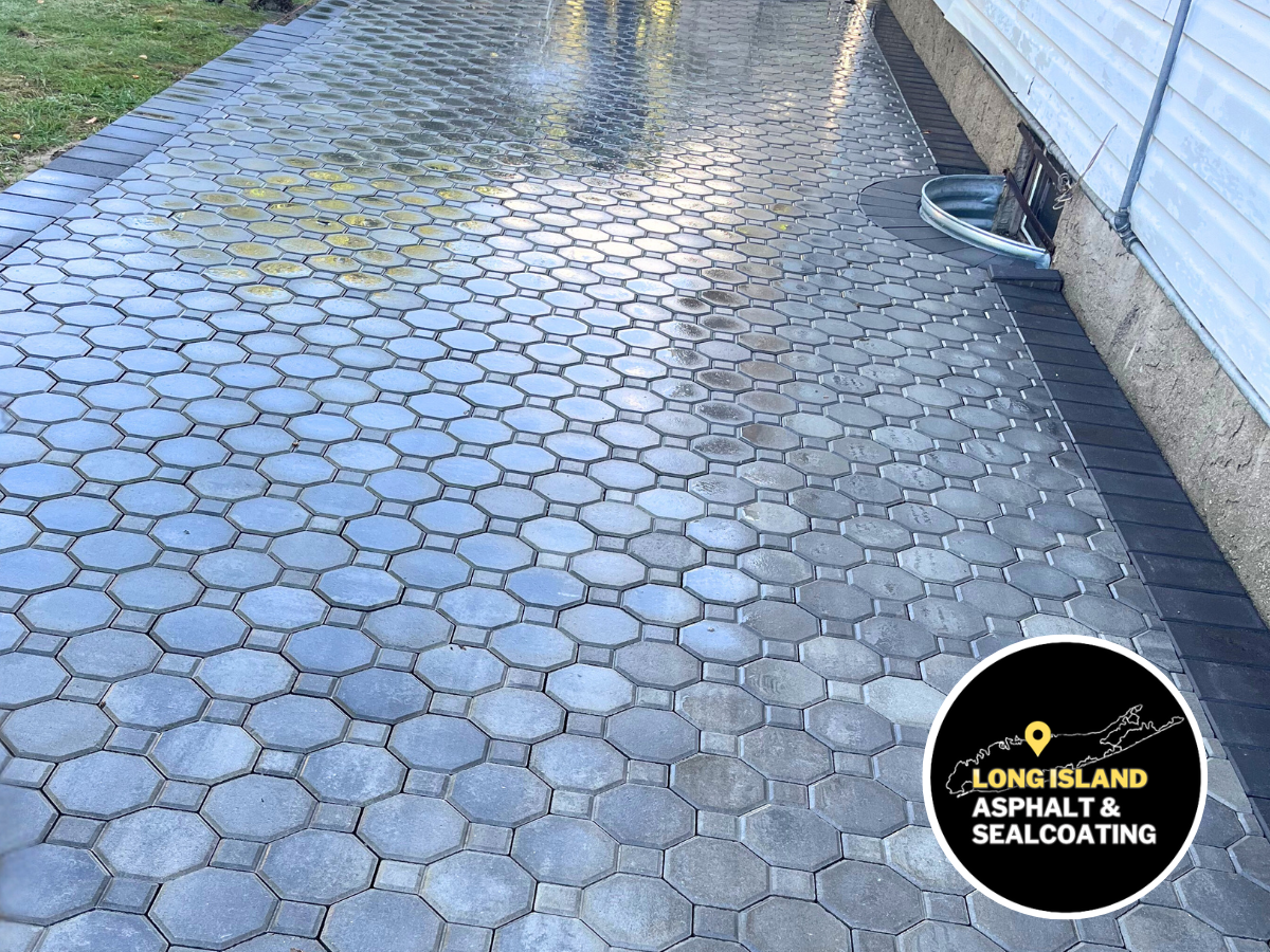 A gray brick masonry patio with bordering steps and brown grass. The Long Island paving logo is visible.